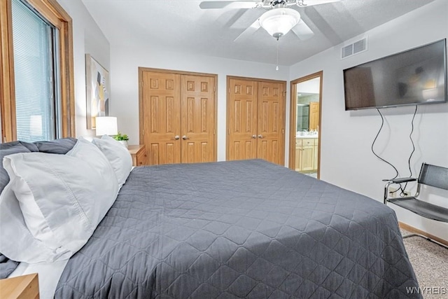8654 Rochester Rd, Royalton, NY 14067 - bedroom with two closets, a ceiling fan, and ensuite bath