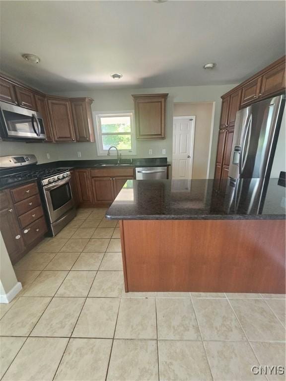 25 Vincent St, Champion, NY 13619 - kitchen with appliances with stainless steel finishes, a sink, light tile patterned flooring, and dark stone counters