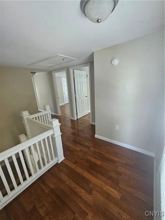 25 Vincent St, Champion, NY 13619 - hallway featuring an upstairs landing, wood finished floors, baseboards, and attic access