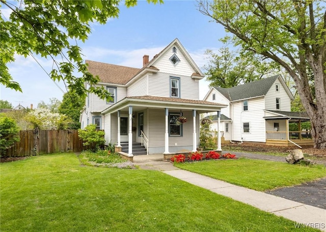 2654 Main St, Newfane, NY 14108 - victorian house featuring a porch and a chimney