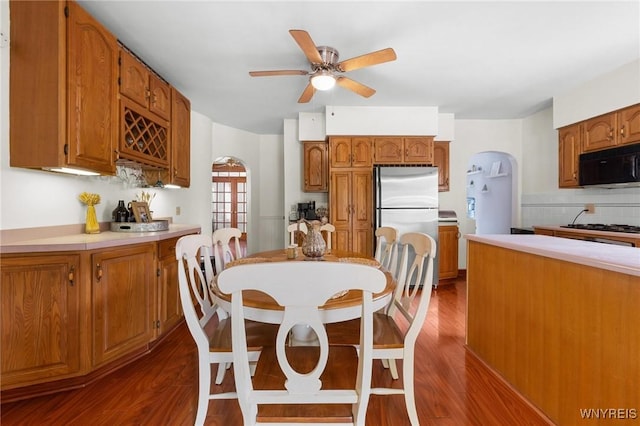 2654 Main St, Newfane, NY 14108 - dining area with dark wood-type flooring, ceiling fan, and arched walkways