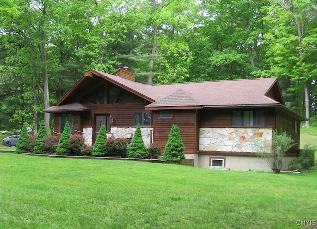 47089 County Route 100, Alexandria, NY 13640 - view of front of home with stone siding, a front yard, a chimney, and a shingled roof