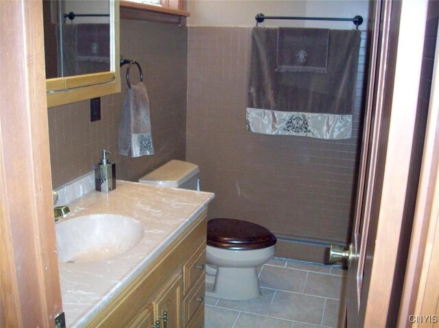47089 County Route 100, Alexandria, NY 13640 - bathroom with tile walls, toilet, tile patterned flooring, and vanity