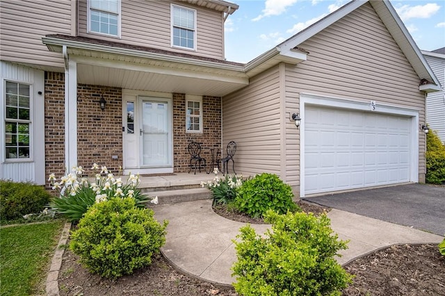 65 Geraldine Pkwy, Gates, NY 14624 - view of front facade with brick siding, an attached garage, and asphalt driveway