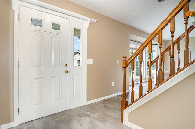 65 Geraldine Pkwy, Gates, NY 14624 - entryway with baseboards, stairway, and a textured ceiling