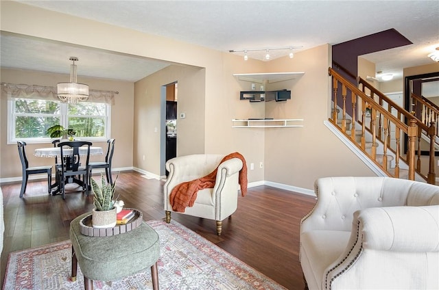 65 Geraldine Pkwy, Gates, NY 14624 - living area featuring wood finished floors, stairway, baseboards, a chandelier, and track lighting