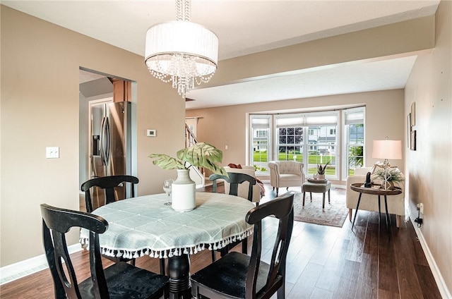 65 Geraldine Pkwy, Gates, NY 14624 - dining area with baseboards, dark wood-type flooring, and a chandelier