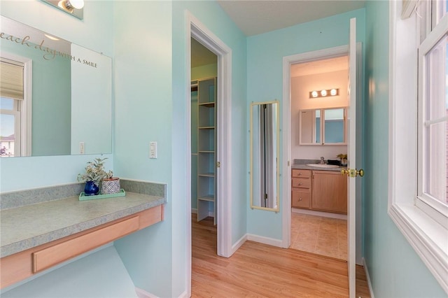 65 Geraldine Pkwy, Gates, NY 14624 - bathroom with vanity, wood finished floors, and baseboards