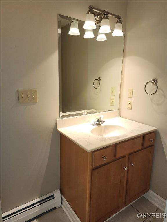 6731 Chestnut Ridge Rd, Orchard Park, NY 14127 - bathroom featuring baseboard heating, vanity, tile patterned floors, and baseboards