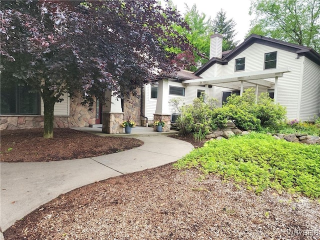 6731 Chestnut Ridge Rd, Orchard Park, NY 14127 - view of front of house featuring stone siding and a chimney
