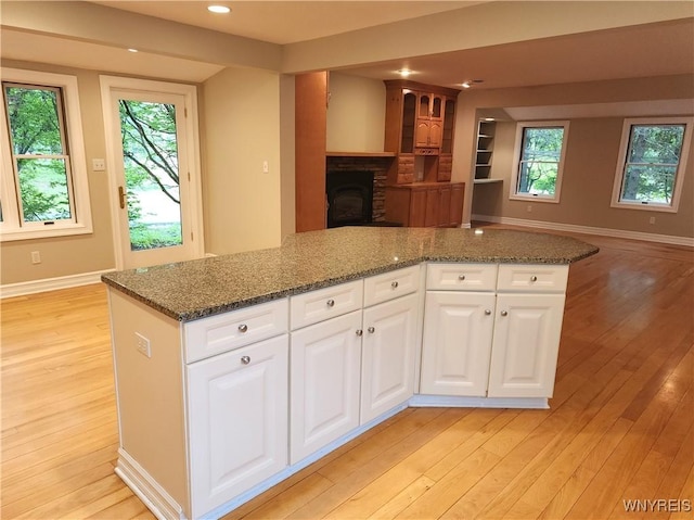 6731 Chestnut Ridge Rd, Orchard Park, NY 14127 - kitchen with open floor plan, light wood finished floors, dark stone counters, and recessed lighting