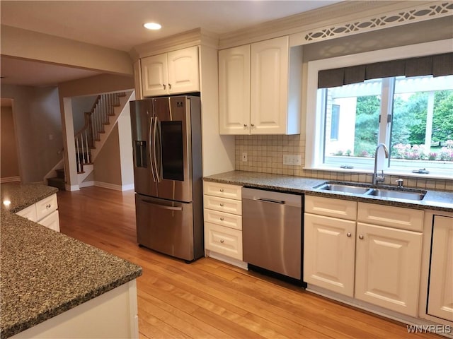 6731 Chestnut Ridge Rd, Orchard Park, NY 14127 - kitchen with appliances with stainless steel finishes, a sink, light wood finished floors, recessed lighting, and backsplash
