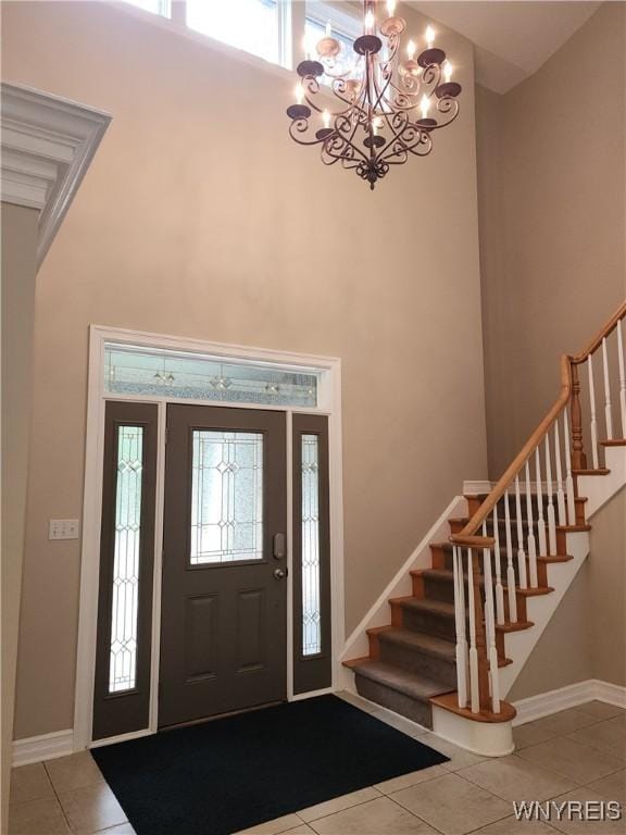 6731 Chestnut Ridge Rd, Orchard Park, NY 14127 - tiled foyer with stairs, a high ceiling, baseboards, and a chandelier