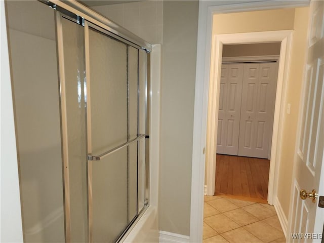 6731 Chestnut Ridge Rd, Orchard Park, NY 14127 - full bath featuring tile patterned floors, baseboards, and bath / shower combo with glass door
