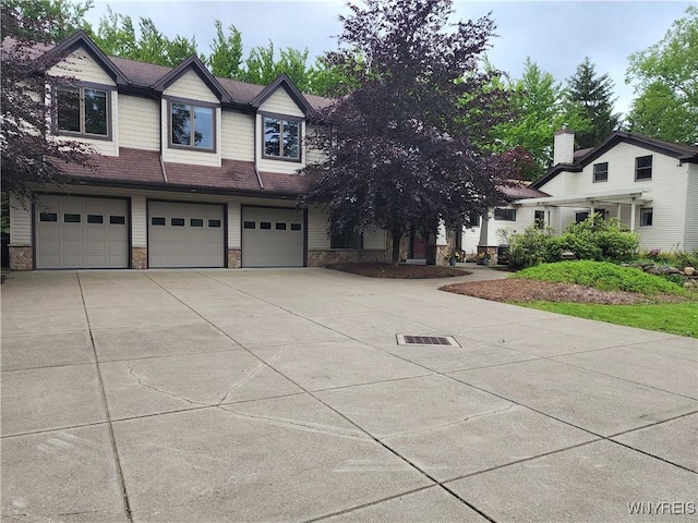 6731 Chestnut Ridge Rd, Orchard Park, NY 14127 - view of front facade featuring stone siding, a garage, and driveway