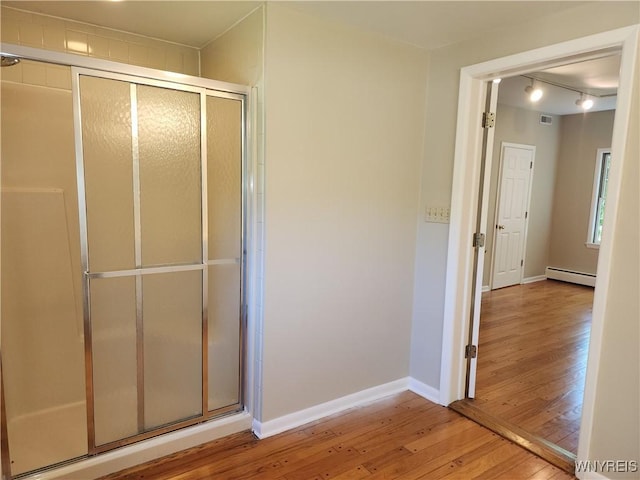 6731 Chestnut Ridge Rd, Orchard Park, NY 14127 - full bath featuring hardwood / wood-style floors, a baseboard radiator, a stall shower, and baseboards