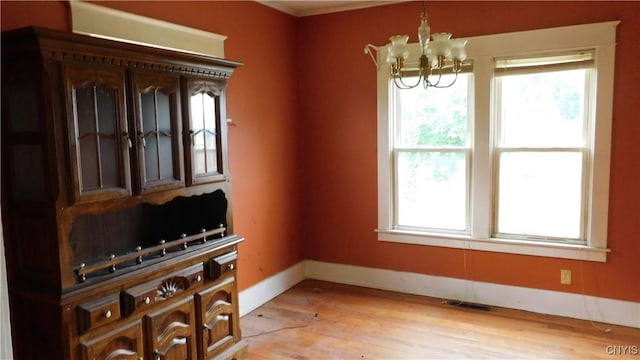 409 E Bloomfield St, Rome-Inside, NY 13440 - unfurnished dining area with plenty of natural light, a chandelier, baseboards, and light wood-style floors