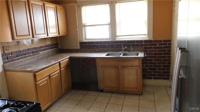 409 E Bloomfield St, Rome-Inside, NY 13440 - kitchen with a sink, freestanding refrigerator, light tile patterned flooring, and brown cabinets