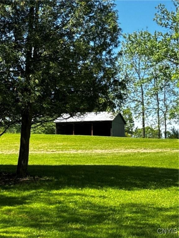 5199 W Lake Rd, Fleming, NY 13021 - view of grassy yard featuring a pole building and an outbuilding