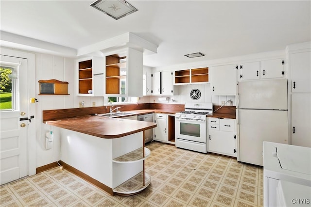5199 W Lake Rd, Fleming, NY 13021 - kitchen featuring open shelves, white appliances, a sink, a peninsula, and white cabinets