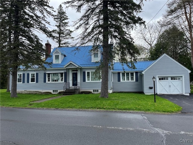 7 Roberts St, Adams, NY 13605 - cape cod house featuring a garage, driveway, a chimney, metal roof, and a front lawn