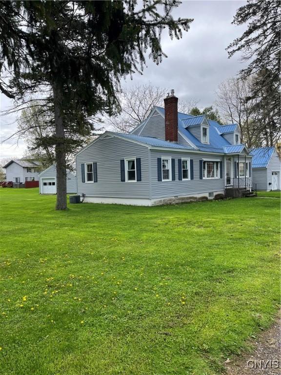 7 Roberts St, Adams, NY 13605 - rear view of property featuring a chimney, a yard, and metal roof