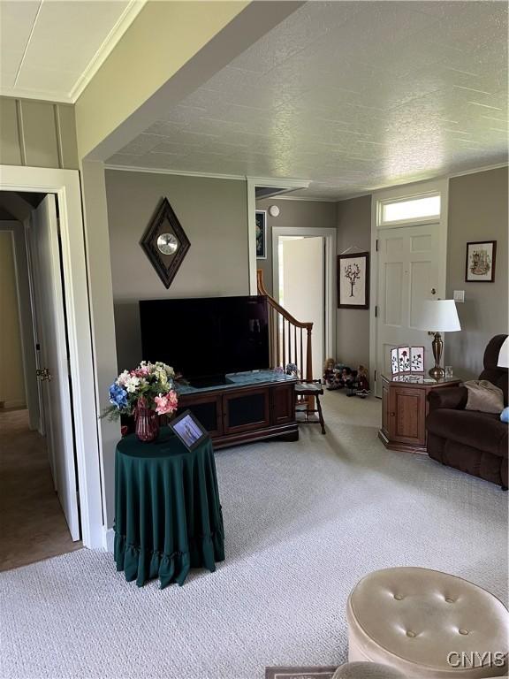 7 Roberts St, Adams, NY 13605 - living room with carpet flooring, crown molding, and stairs