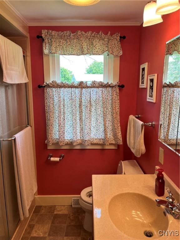 7 Roberts St, Adams, NY 13605 - bathroom featuring healthy amount of natural light, toilet, a shower stall, crown molding, and baseboards