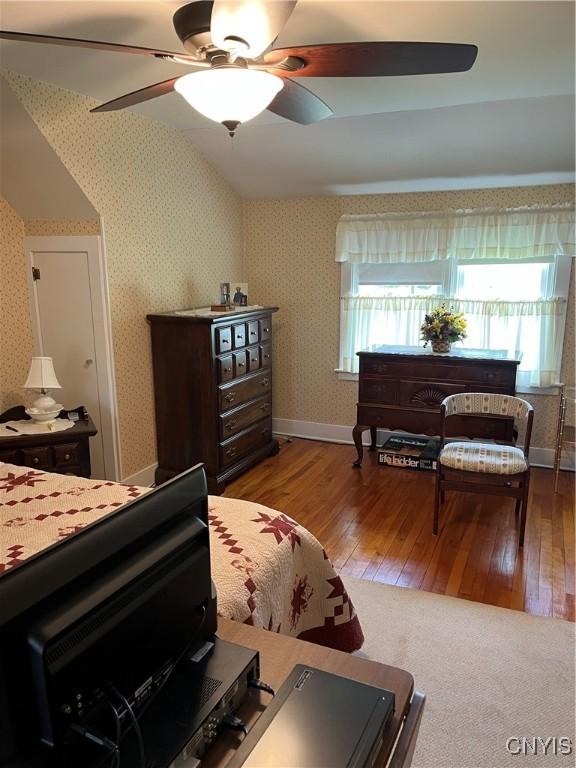 7 Roberts St, Adams, NY 13605 - bedroom featuring wallpapered walls, hardwood / wood-style floors, vaulted ceiling, and a ceiling fan