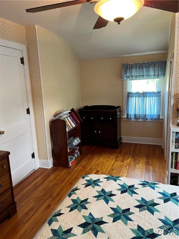 7 Roberts St, Adams, NY 13605 - bedroom with hardwood / wood-style floors, wallpapered walls, ceiling fan, and baseboards