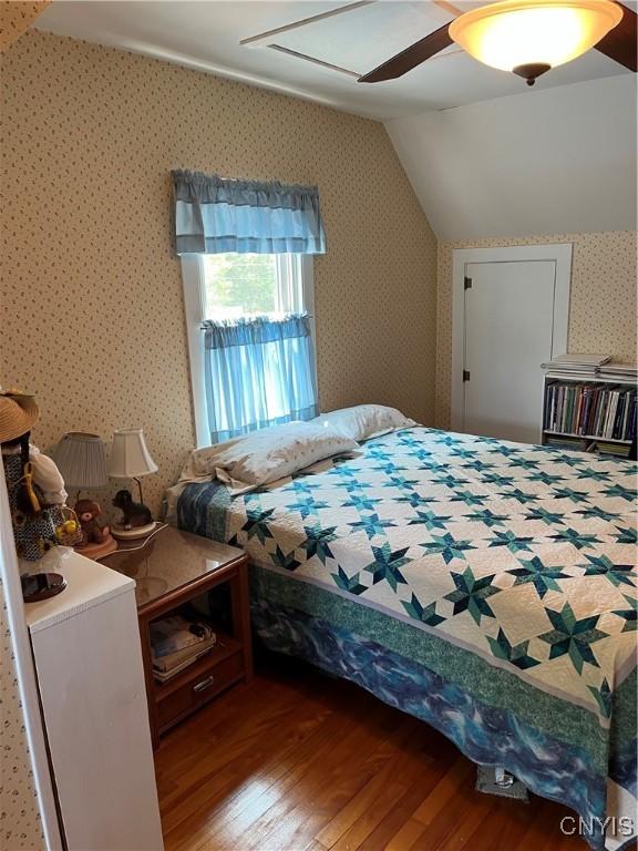 7 Roberts St, Adams, NY 13605 - bedroom with wood finished floors, lofted ceiling, wallpapered walls, and ceiling fan
