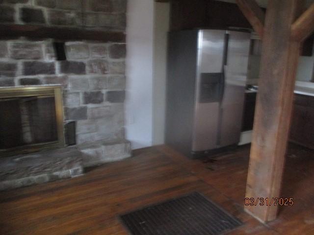3709 Dean Rd, Hector, NY 14869 - detailed view of a fireplace, stainless steel fridge, and wood finished floors
