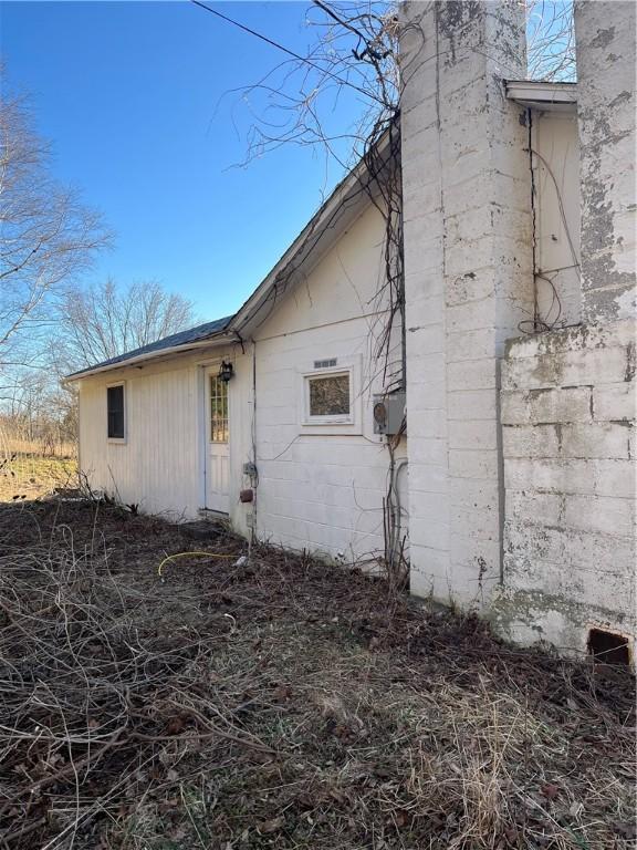 3709 Dean Rd, Hector, NY 14869 - view of home's exterior featuring concrete block siding and a chimney