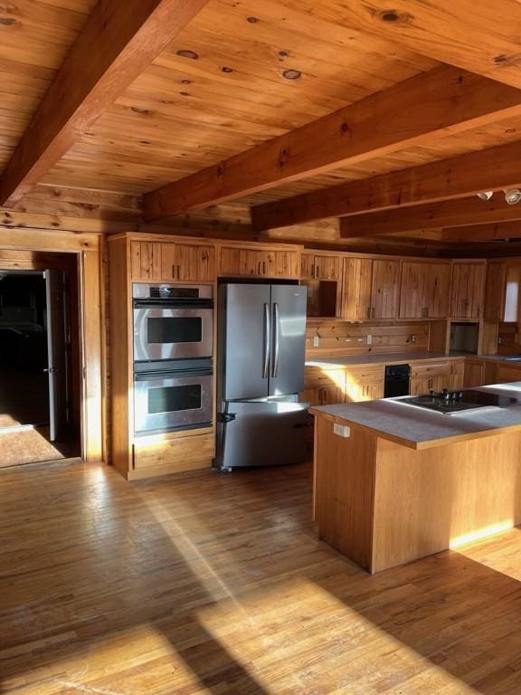 3709 Dean Rd, Hector, NY 14869 - kitchen featuring appliances with stainless steel finishes, wooden ceiling with exposed beams, wood finished floors, brown cabinets, and wooden walls