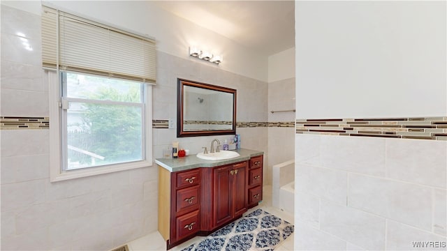 239 Keystone St, Buffalo, NY 14211 - full bathroom with tile walls, vanity, a tub to relax in, and tile patterned flooring