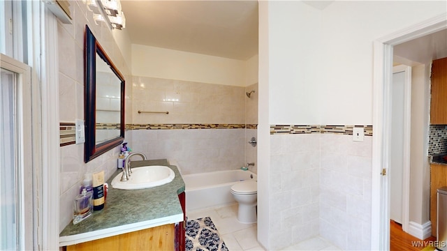 239 Keystone St, Buffalo, NY 14211 - bathroom featuring toilet, vanity, tile walls, and bathing tub / shower combination