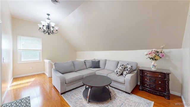 239 Keystone St, Buffalo, NY 14211 - living area featuring vaulted ceiling, light wood-style floors, a chandelier, and baseboards