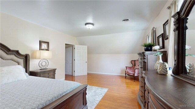 239 Keystone St, Buffalo, NY 14211 - bedroom featuring light wood finished floors, baseboards, and vaulted ceiling