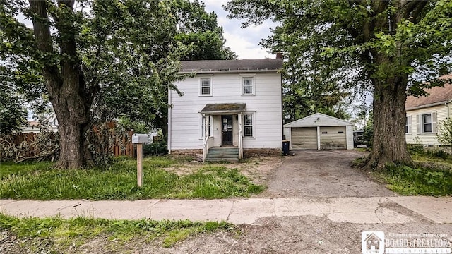 380 Ontario St, Lockport-City, NY 14094 - view of front of house with an outdoor structure, a detached garage, and a chimney