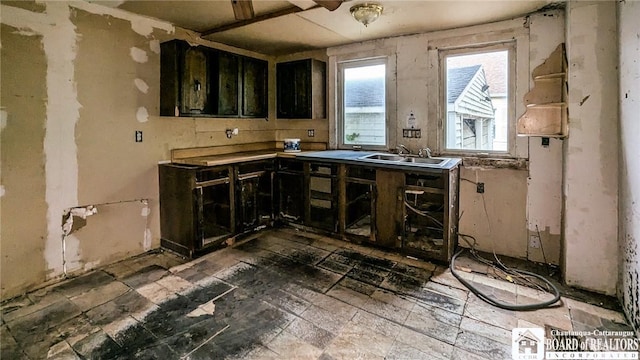 380 Ontario St, Lockport-City, NY 14094 - kitchen featuring a sink and dark cabinetry