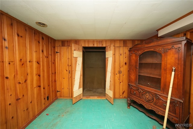 1104 98th St, Niagara Falls, NY 14304 - unfurnished bedroom featuring wood walls and tile patterned floors