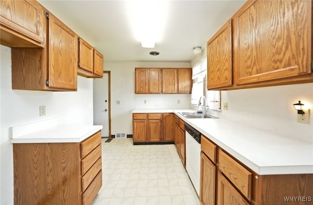 1104 98th St, Niagara Falls, NY 14304 - kitchen featuring white dishwasher, brown cabinetry, light flooring, and a sink