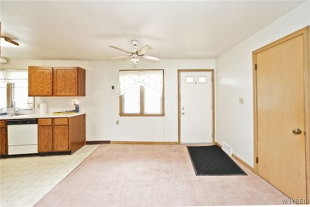 1104 98th St, Niagara Falls, NY 14304 - kitchen featuring white dishwasher, ceiling fan, brown cabinetry, light countertops, and baseboards
