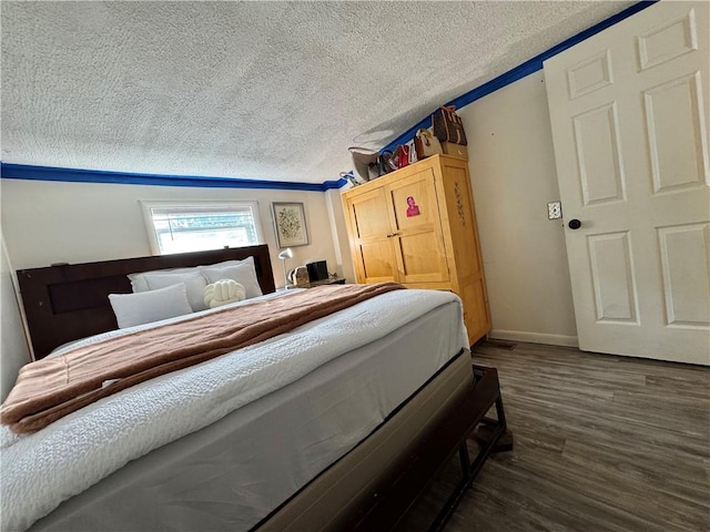 77 Mosley Rd, Greece, NY 14616 - bedroom featuring a textured ceiling, dark wood-type flooring, and baseboards