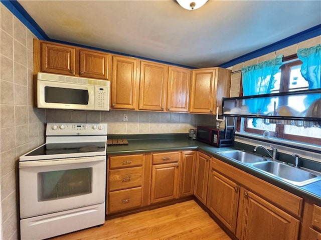 77 Mosley Rd, Greece, NY 14616 - kitchen with white appliances, a sink, dark countertops, and light wood-style flooring