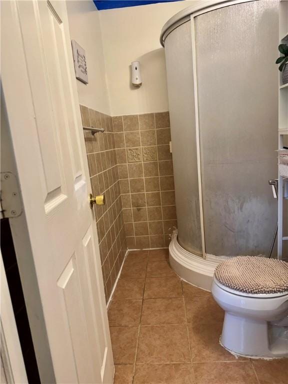 77 Mosley Rd, Greece, NY 14616 - full bath with a stall shower, tile walls, tile patterned floors, toilet, and wainscoting