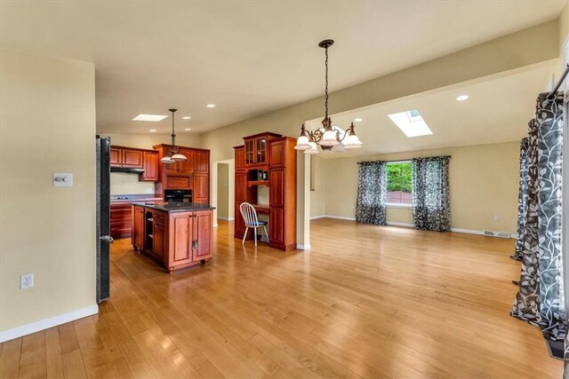 2556 County Highway 22, Richfield, NY 13439 - kitchen featuring dark countertops, open floor plan, a chandelier, light wood finished floors, and baseboards