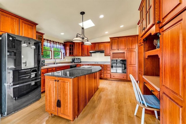2556 County Highway 22, Richfield, NY 13439 - kitchen featuring black appliances, a skylight, a kitchen island, light wood-type flooring, and vaulted ceiling