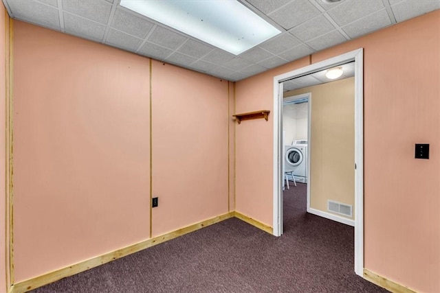 2556 County Highway 22, Richfield, NY 13439 - unfurnished room featuring washer / dryer, dark colored carpet, baseboards, and a drop ceiling