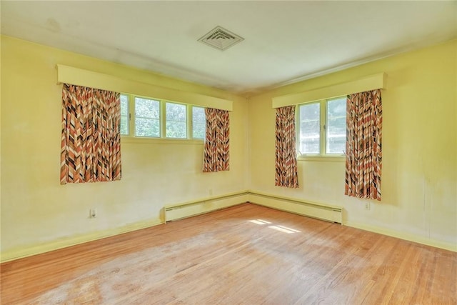 492 Drumm Rd, Webster, NY 14580 - unfurnished room featuring wood finished floors, healthy amount of natural light, and baseboards